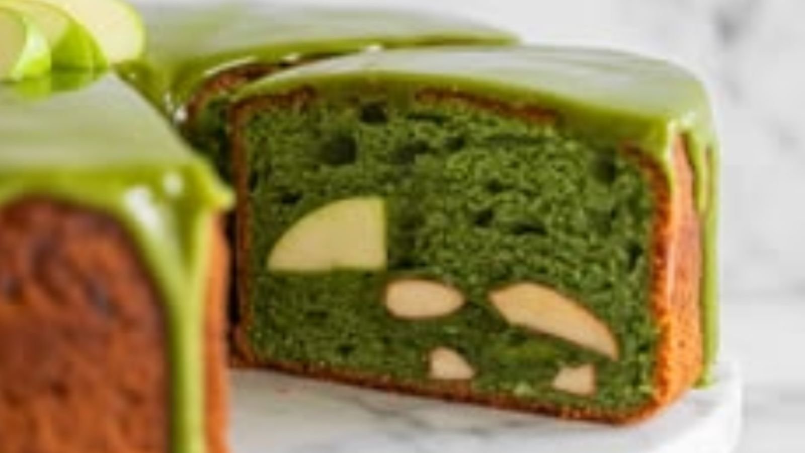 Normal matcha cake color gradient Cross-section of a baked matcha cake showing why matcha turns brown in baking: green crumb at the center darkening to olive at the edges and a brown crust