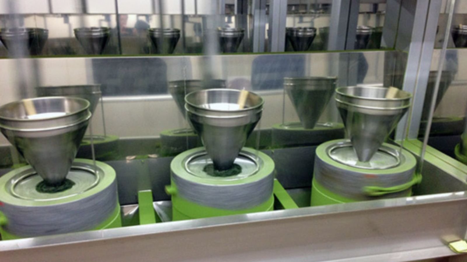 Modern matcha production in Mengding Modern Chinese matcha factory production in Mengding showing steamed tencha processing and closed-loop low-temperature automated milling